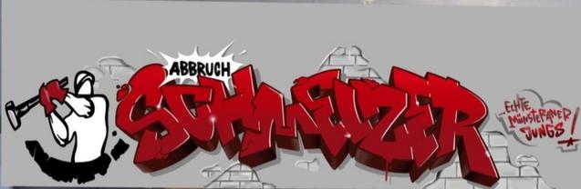 Graffiti mit der Aufschrift „Abbruch Schweitzer“ in roten Buchstaben, ergänzt durch eine ikonische Figur mit Hammer.